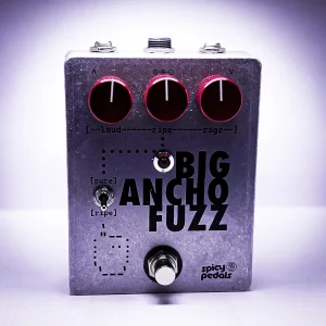 Big Ancho Fuzz lit by a purple key light, seen from three quarters, the aluminium enclosure and dark red knobs against a violet glow.